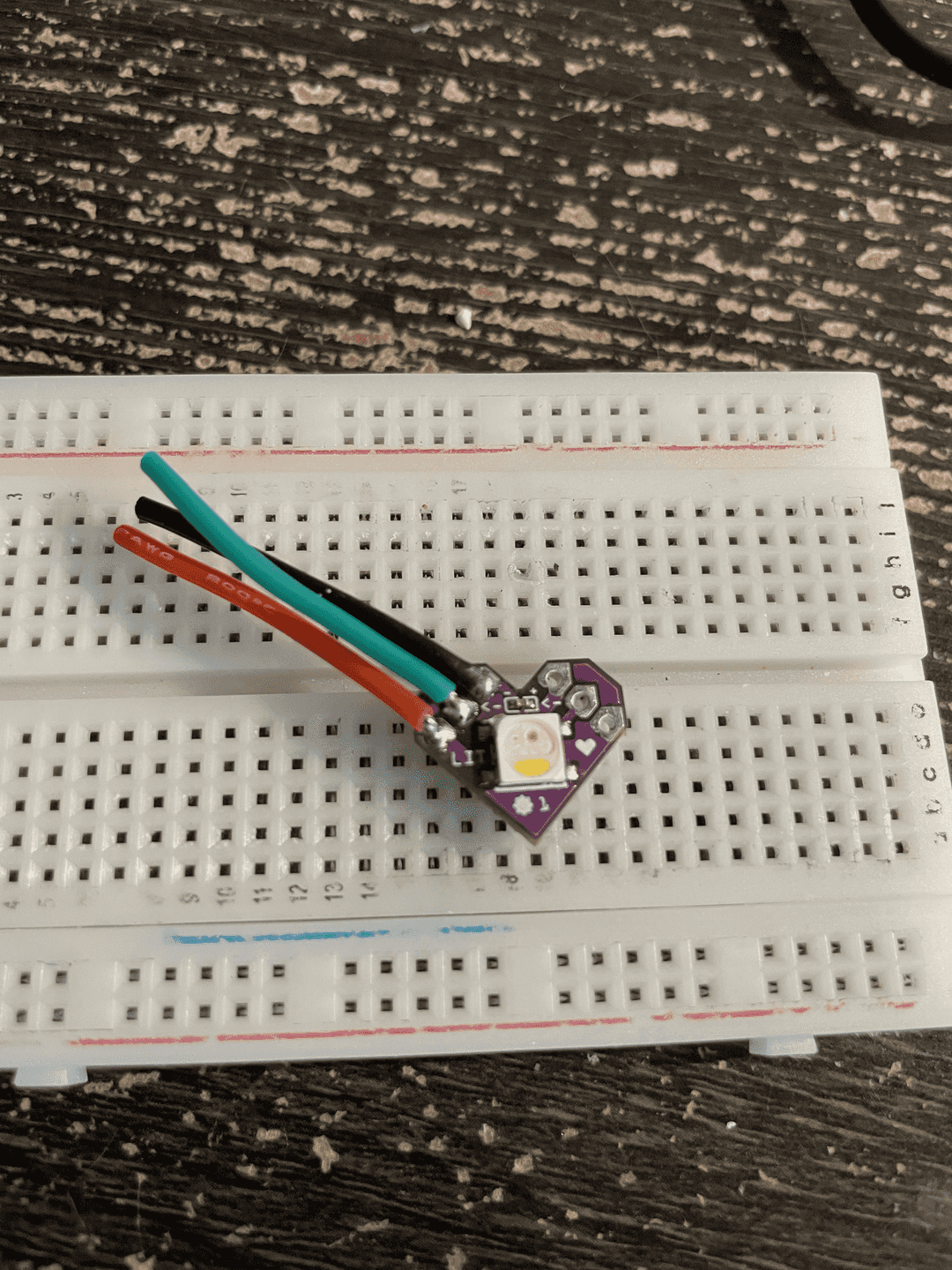 Lit PCB wired on one side.